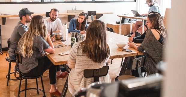 People gathered around a table discussing strategy